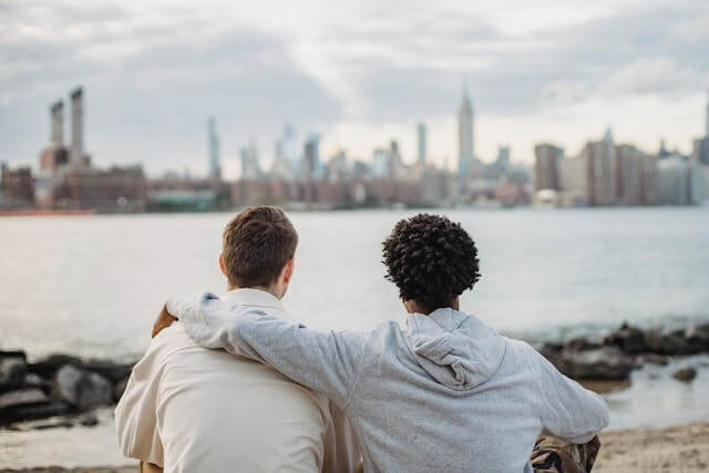 Image of a man hugging his friend with one arm