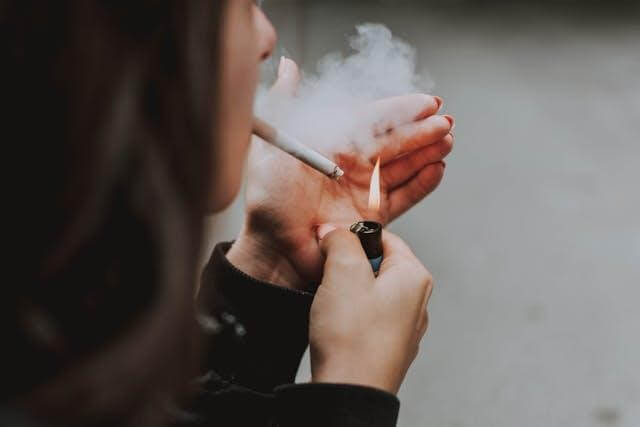 Image of A woman smoking a cigarette